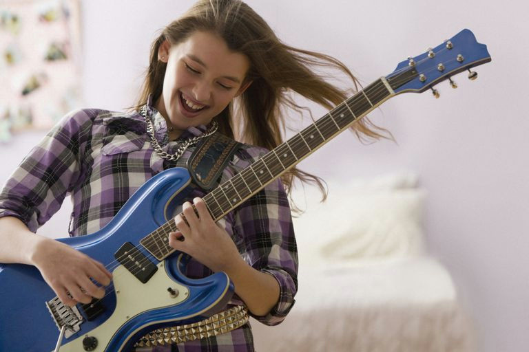 Drawing Girl Playing Guitar Best First songs to Learn On Electric Guitar