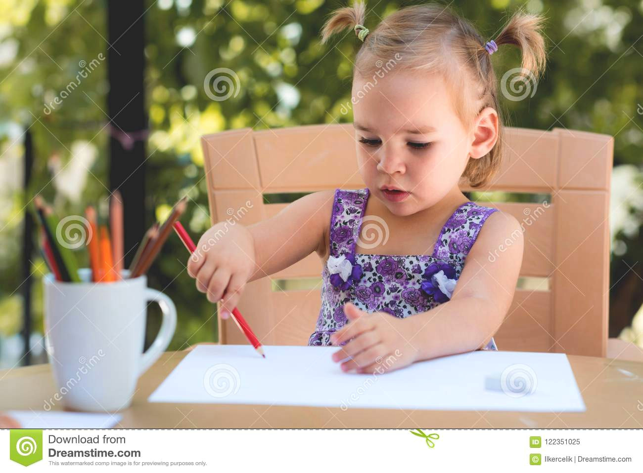 Drawing Of A Girl Sitting at A Desk Happy Smiling Baby Girl Drawing Pictures Outdoors Stock Image
