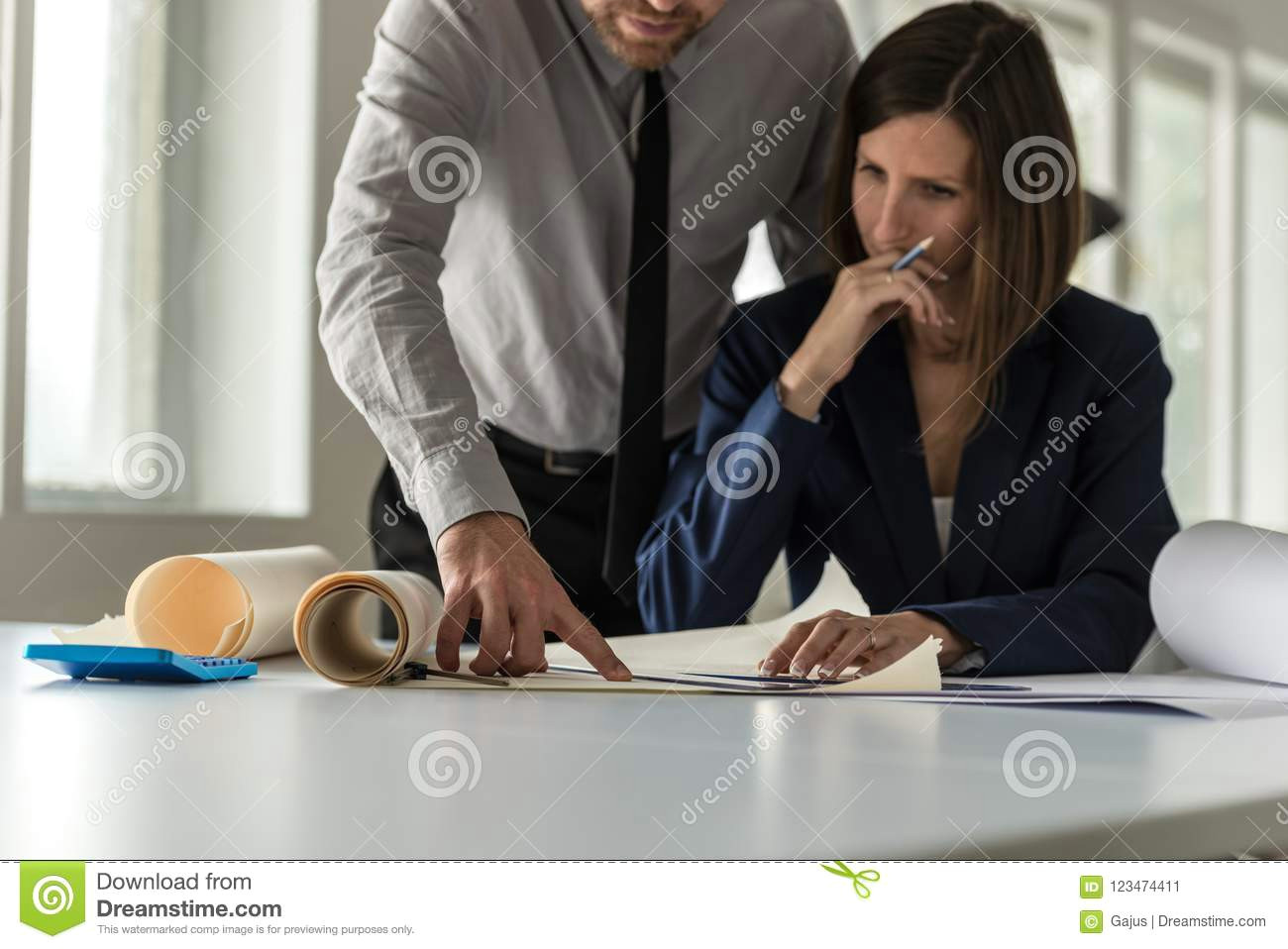 Drawing Of A Girl Sitting at A Desk Two Architects Discussing A Drawing or Blueprint Stock Image Image
