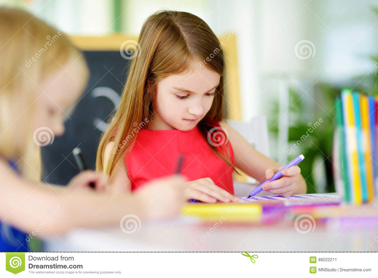Drawing Of A Girl Sitting at A Desk Two Cute Little Sisters Drawing with Colorful Pencils at A Daycare