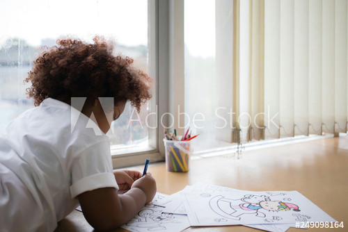 Girl Lying Down Drawing Mixed Race Girl Tanned Skin Curly Short Hair Lying Down
